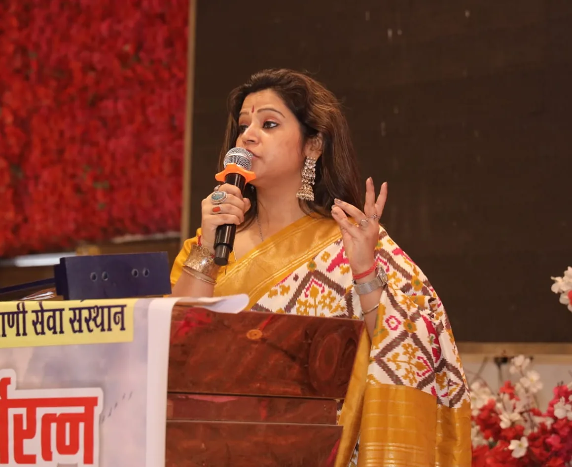 Nancy speaking at a podium